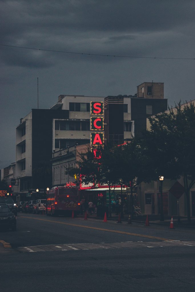 SCAD's Trustees Theater lit up at night on Broughton Street in Savannah